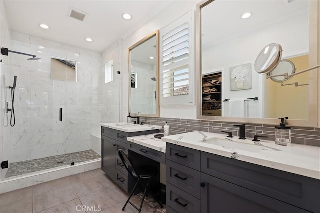 bathroom with backsplash, visible vents, tile patterned flooring, a stall shower, and vanity