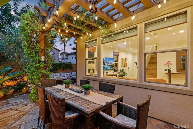 view of patio / terrace with a pergola and outdoor dining area