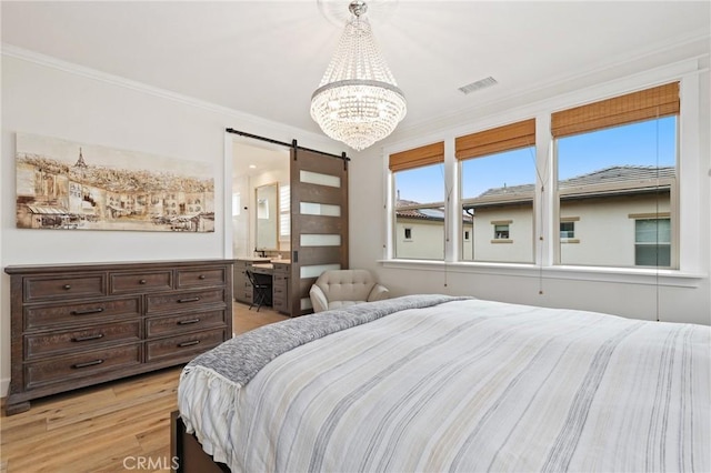 bedroom featuring visible vents, a barn door, crown molding, and an inviting chandelier