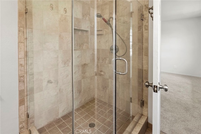 full bath with baseboards and a shower stall