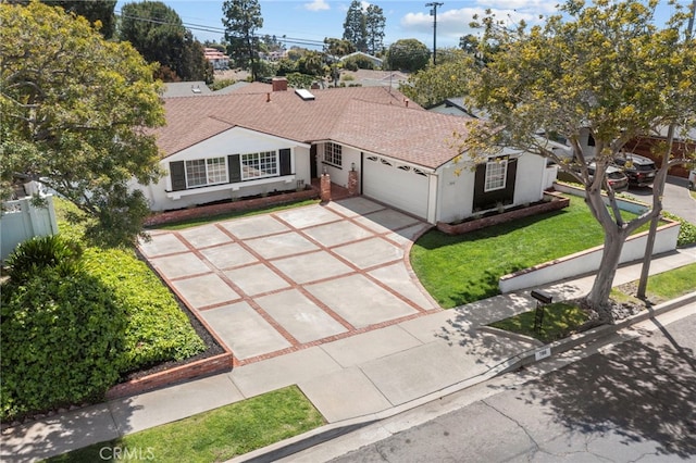 ranch-style home featuring an attached garage, driveway, roof with shingles, and stucco siding