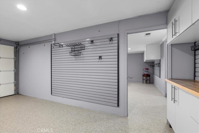 garage with recessed lighting and visible vents