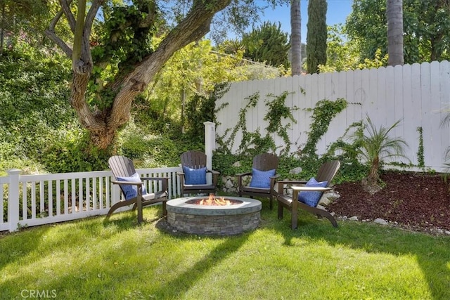 view of yard with fence and a fire pit