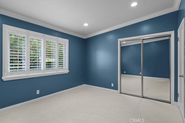 unfurnished bedroom featuring recessed lighting, carpet, baseboards, and a closet