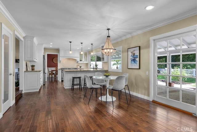 dining room featuring baseboards, recessed lighting, a healthy amount of sunlight, and dark wood-style floors