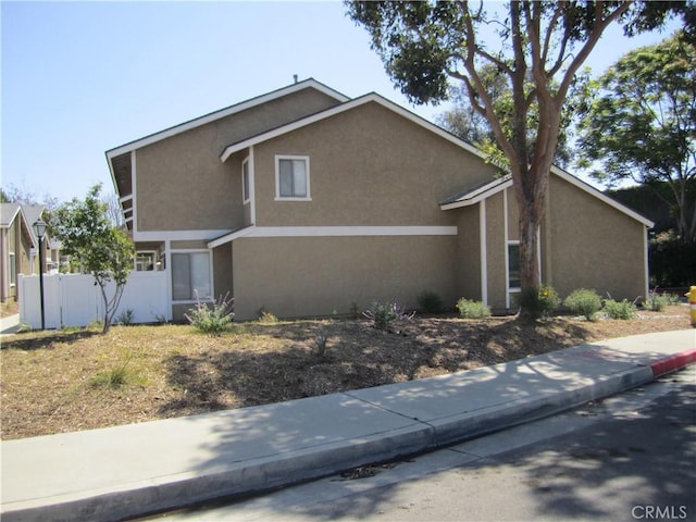 2321 S Magnolia Ave Unit 6A, Ontario, CA 91762 - view of front of house featuring stucco siding and fence