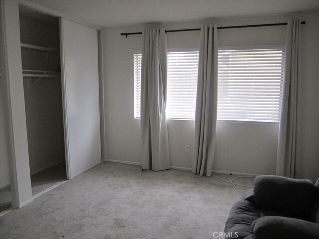 2321 S Magnolia Ave Unit 6A, Ontario, CA 91762 - carpeted bedroom featuring baseboards and multiple windows