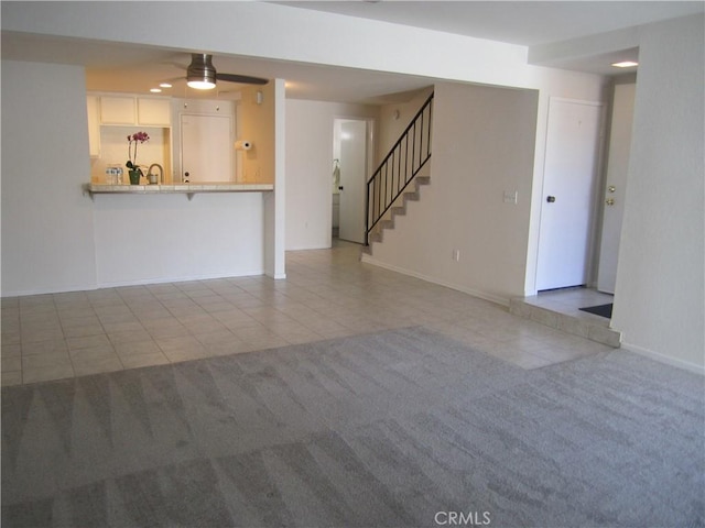 2321 S Magnolia Ave Unit 6A, Ontario, CA 91762 - unfurnished living room featuring baseboards, ceiling fan, tile patterned floors, and stairway