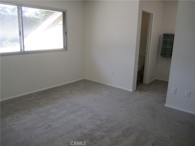 2321 S Magnolia Ave Unit 6A, Ontario, CA 91762 - spare room featuring baseboards and carpet