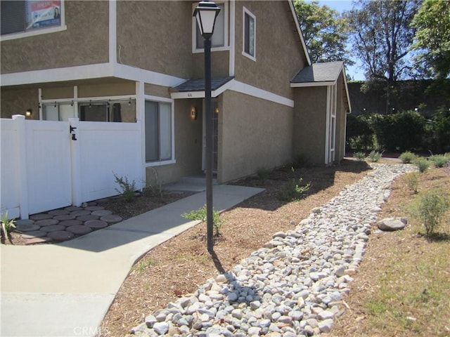 2321 S Magnolia Ave Unit 6A, Ontario, CA 91762 - view of home's exterior featuring fence and stucco siding