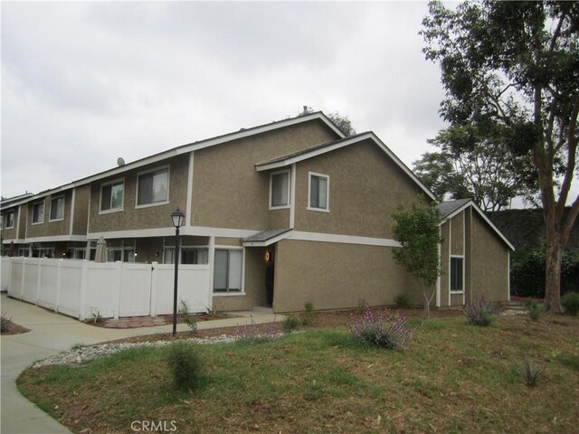 2321 S Magnolia Ave Unit 6A, Ontario, CA 91762 - view of front of home with fence and stucco siding