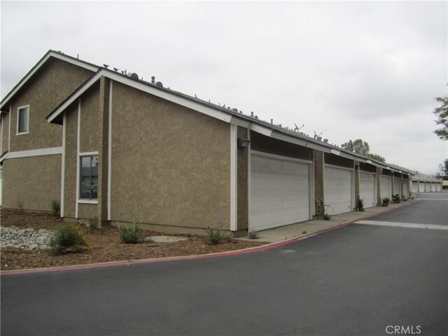 2321 S Magnolia Ave Unit 6A, Ontario, CA 91762 - view of property exterior featuring stucco siding and community garages