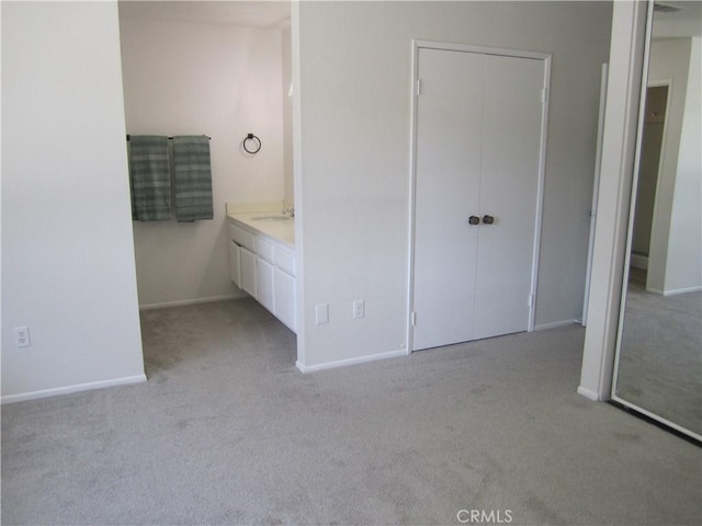 2321 S Magnolia Ave Unit 6A, Ontario, CA 91762 - unfurnished bedroom featuring a sink, baseboards, light carpet, and a closet
