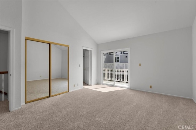 unfurnished bedroom with high vaulted ceiling, baseboards, carpet, and access to exterior