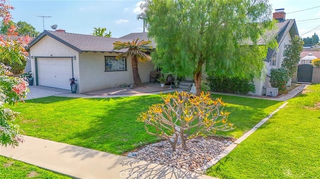 view of front of house with an attached garage, a front lawn, and stucco siding