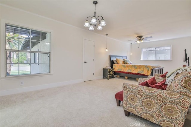 carpeted bedroom with an inviting chandelier, baseboards, and ornamental molding