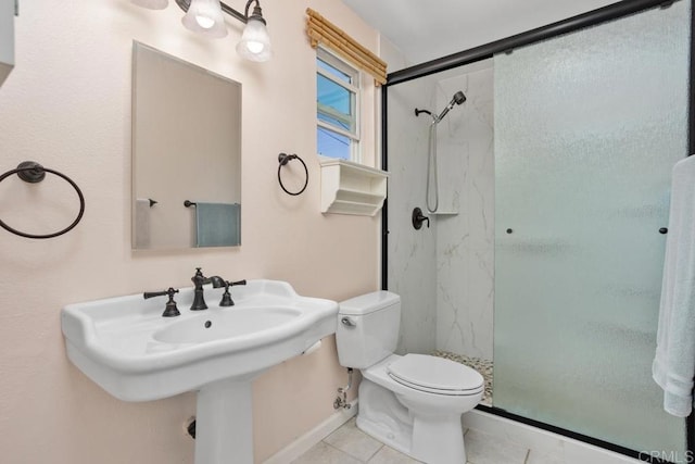 full bathroom featuring a sink, baseboards, tile patterned floors, toilet, and a marble finish shower