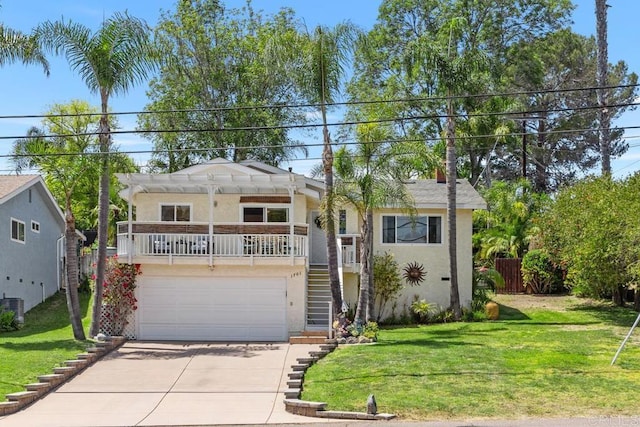 view of front facade with concrete driveway, a front lawn, stairs, and stucco siding