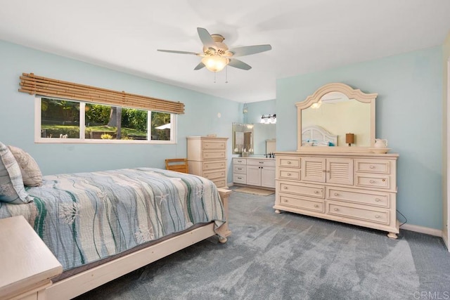 bedroom featuring carpet floors, ceiling fan, and ensuite bath