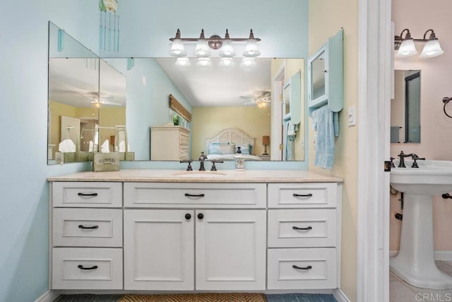 bathroom featuring a sink, baseboards, and ceiling fan