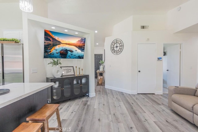 36711 Silverspur Ln, Palmdale, CA 93550 - living area with a towering ceiling, visible vents, baseboards, recessed lighting, and light wood-style flooring