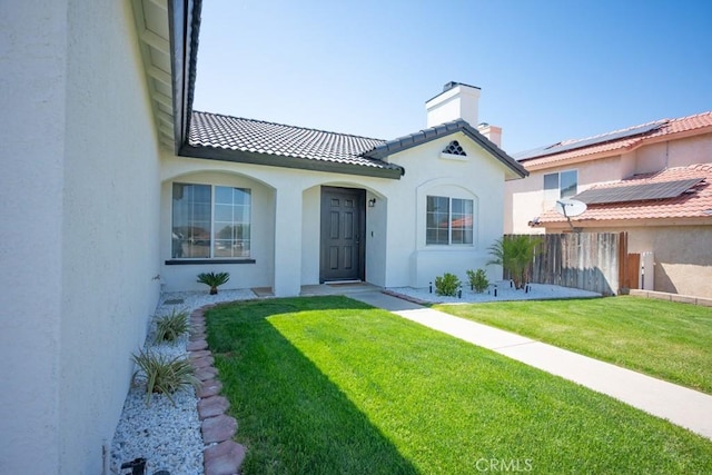 36711 Silverspur Ln, Palmdale, CA 93550 - mediterranean / spanish home featuring fence, a front yard, stucco siding, a chimney, and a tiled roof