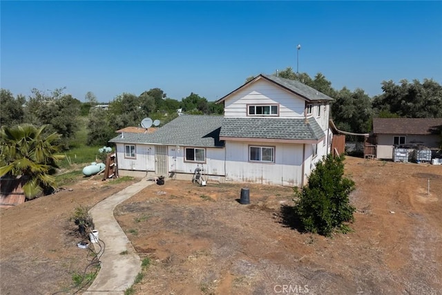 view of front of house featuring roof with shingles