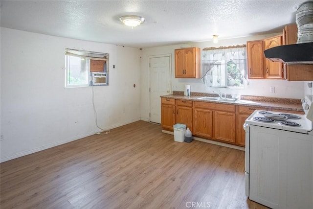 kitchen with island exhaust hood, a sink, white range with electric stovetop, and a wealth of natural light
