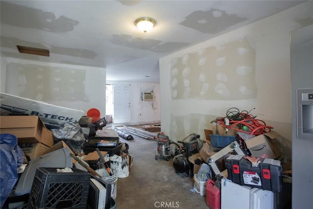 unfurnished living room with a wall unit AC and unfinished concrete flooring