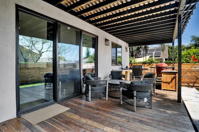 deck featuring fence and a pergola