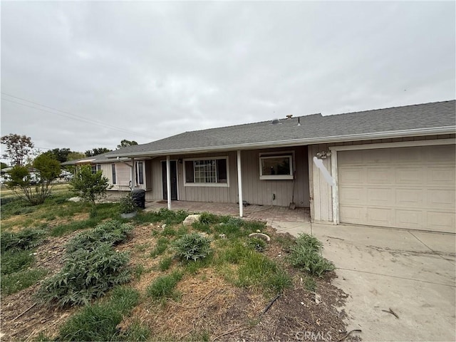 single story home featuring an attached garage and concrete driveway
