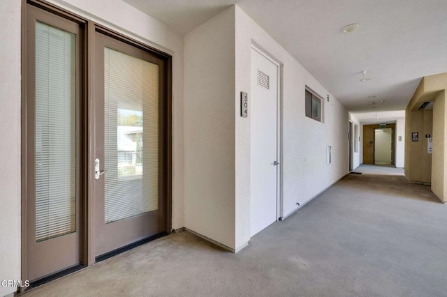 hallway with light colored carpet