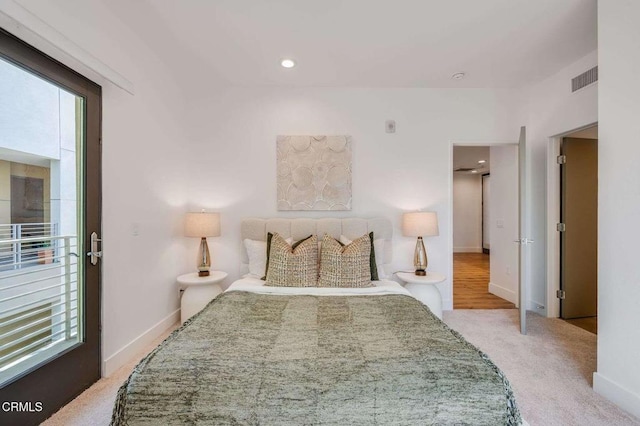 carpeted bedroom featuring baseboards and visible vents