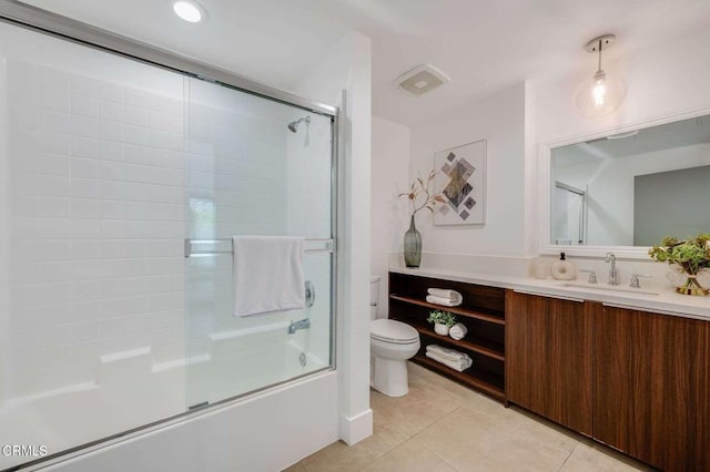 bathroom featuring vanity, toilet, tile patterned floors, combined bath / shower with glass door, and visible vents