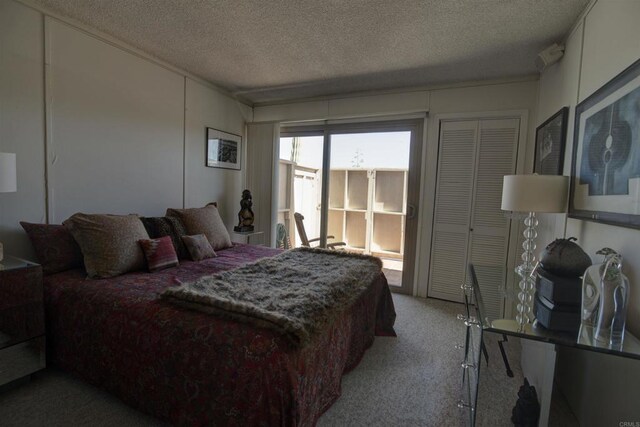 bedroom featuring a textured ceiling and carpet