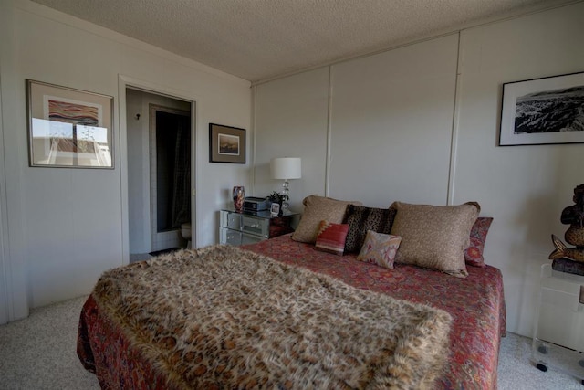 carpeted bedroom featuring a textured ceiling