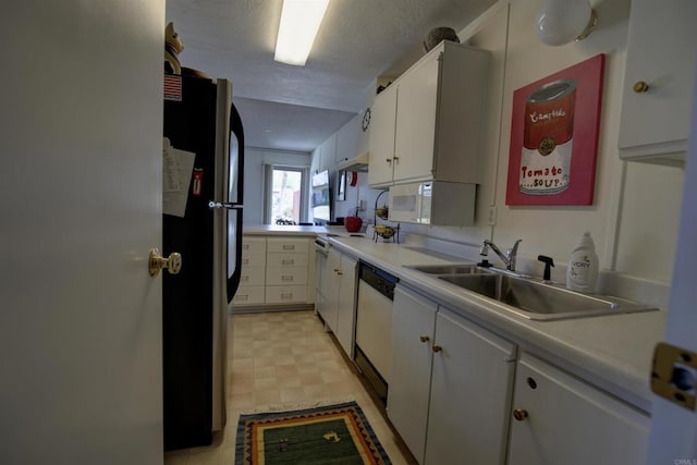 kitchen featuring white appliances, white cabinets, a sink, and light countertops