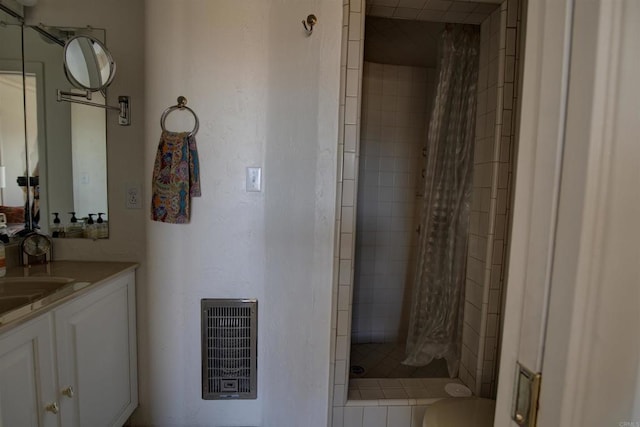bathroom featuring visible vents, a shower stall, and vanity