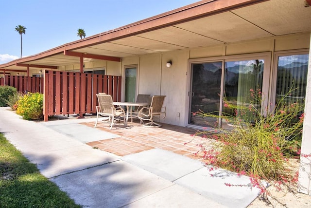 view of patio with fence and outdoor dining area