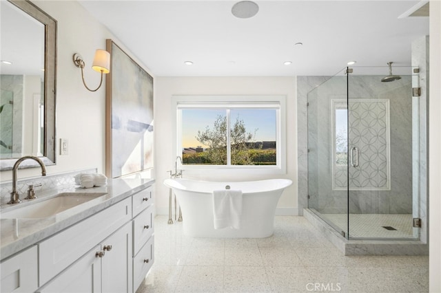 full bathroom with plenty of natural light, vanity, a soaking tub, and a shower stall