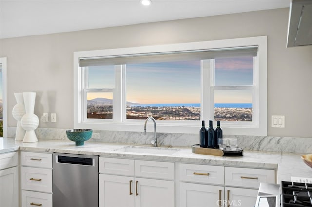 kitchen featuring white cabinets, light stone counters, a sink, recessed lighting, and stainless steel dishwasher