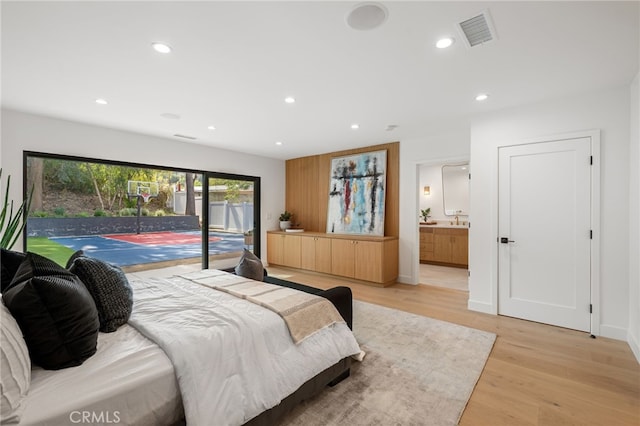 bedroom with access to outside, recessed lighting, light wood-style flooring, and visible vents
