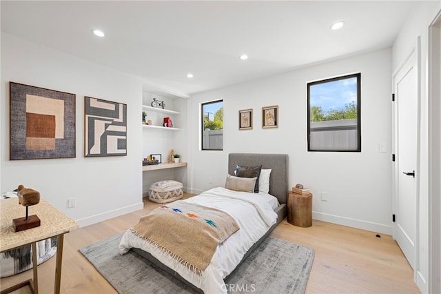 bedroom with recessed lighting and light wood-type flooring