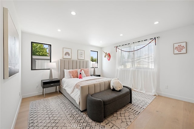 bedroom featuring baseboards, recessed lighting, and light wood-style flooring