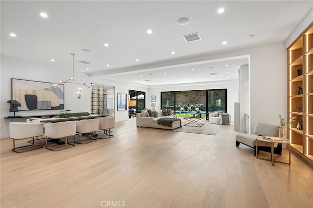 living room with recessed lighting, visible vents, and light wood-style floors