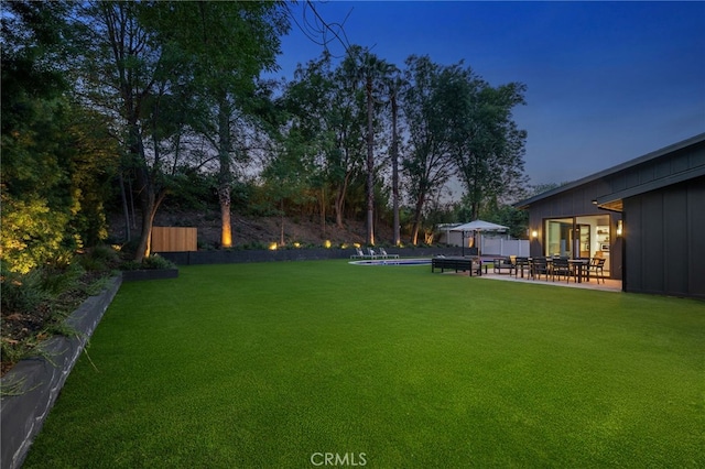 view of yard with a fenced backyard, a patio area, and an outdoor pool