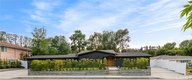 mid-century modern home with fence