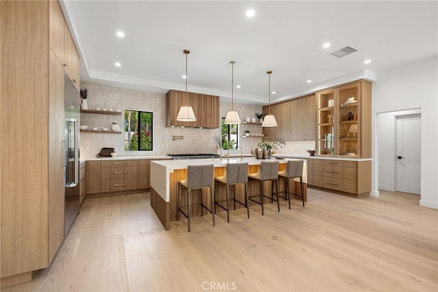 kitchen with open shelves, visible vents, modern cabinets, and light wood finished floors