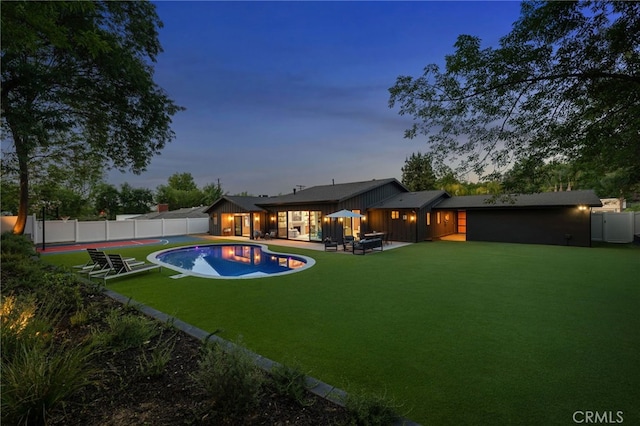 view of pool featuring a lawn, a fenced backyard, a fenced in pool, and a patio