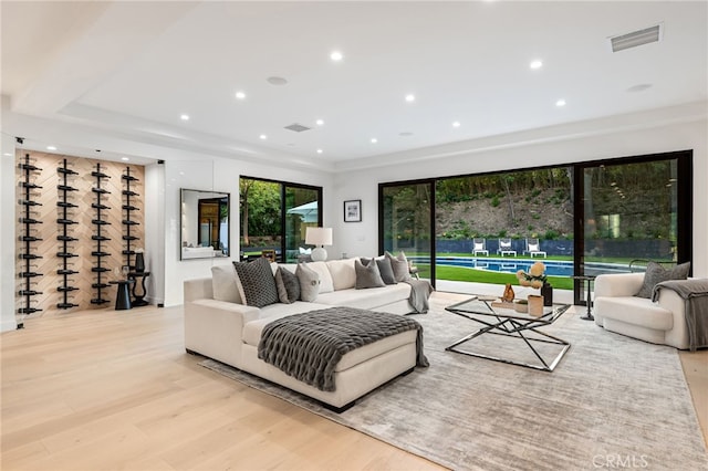 living room with recessed lighting, visible vents, and light wood-style floors